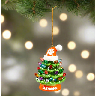 This Clemson holiday ornament is a ceramic tree with Christmas lights with an orange Clemson base topped with a orange Clemson Santa hat. Perfect gift for any Clemson fan.